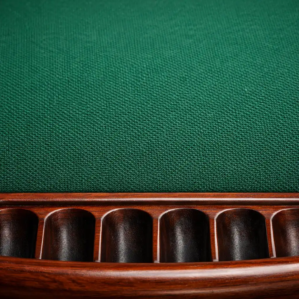 Extreme close-up of green felt texture and wooden chip tray on a poker table
